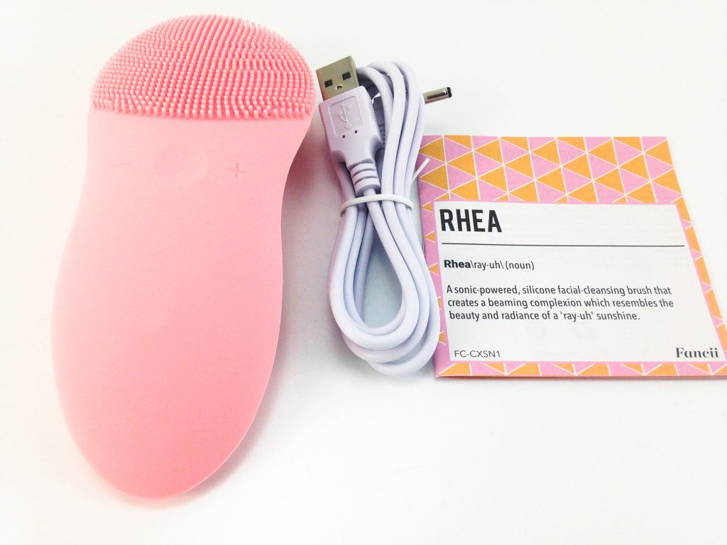 Fancii Rhea Facial Brush Image shows the included contents in a laid out position.