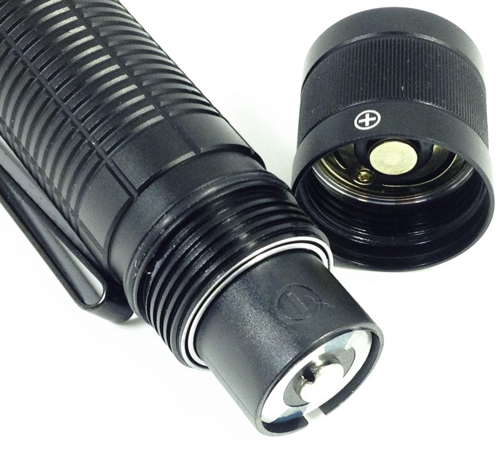 Olight M2T Warrior Flashlight Image shows the supplied batteries inside the flashlight.