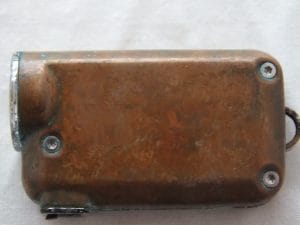 A copper patina on the side of the TINI Cu