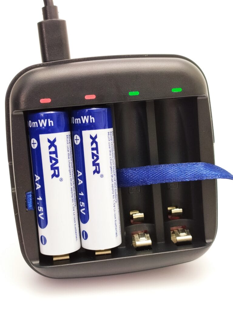Image shows 2x AA XTAR batteries being charged
