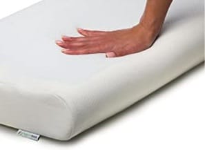 Image shows a Supportiback pillow being pressed down with a right hand.