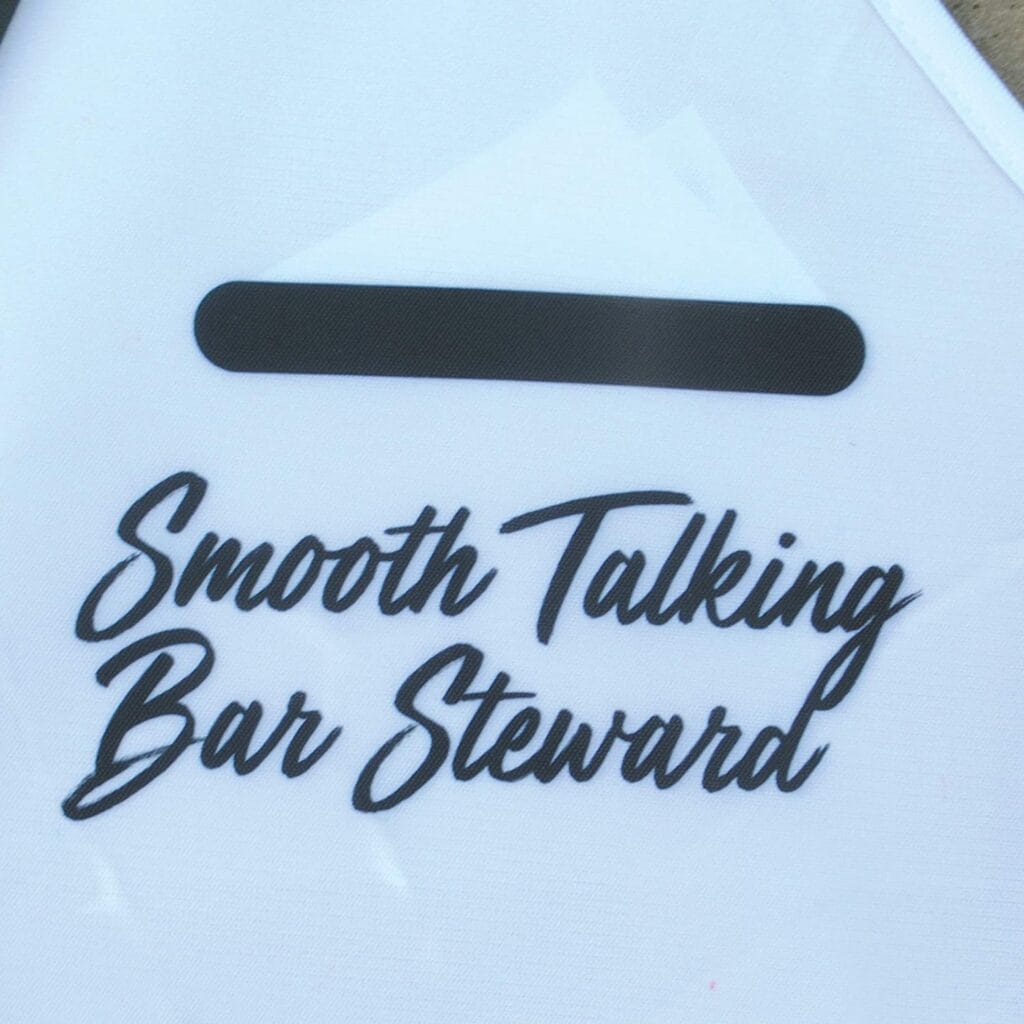 Image shows the print of the bar steward side of the apron. Text says, Smooth Talking Bar Steward.