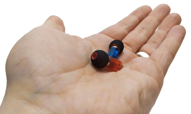 Image shows the Neon earphones in the palm of the left hand.