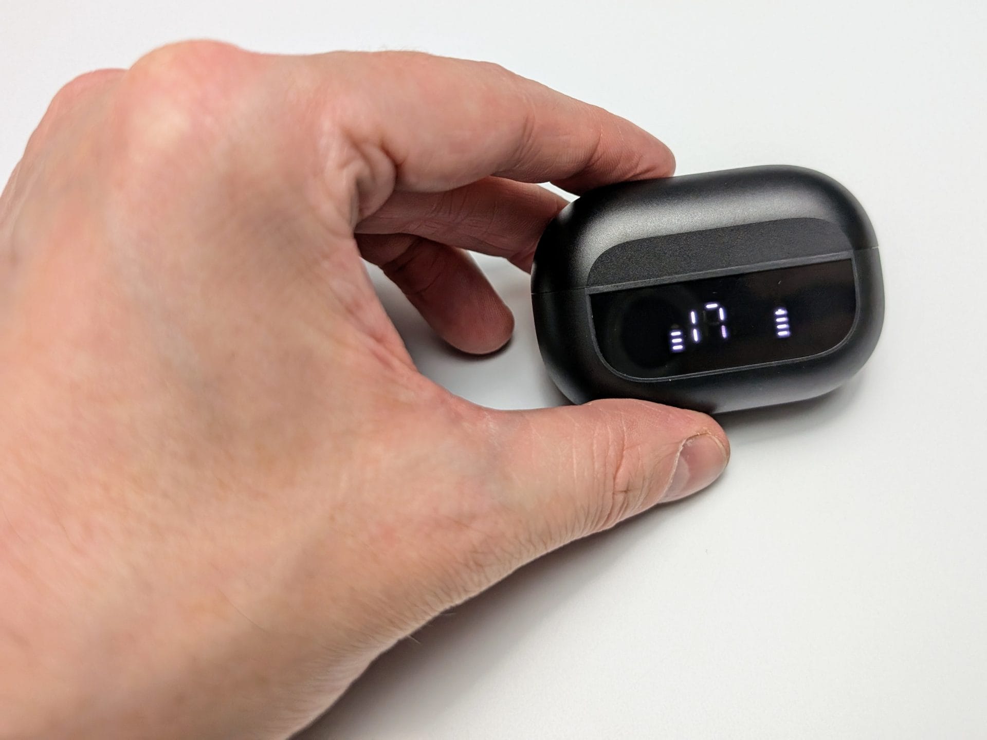 Image shows the charging case in my left hand.