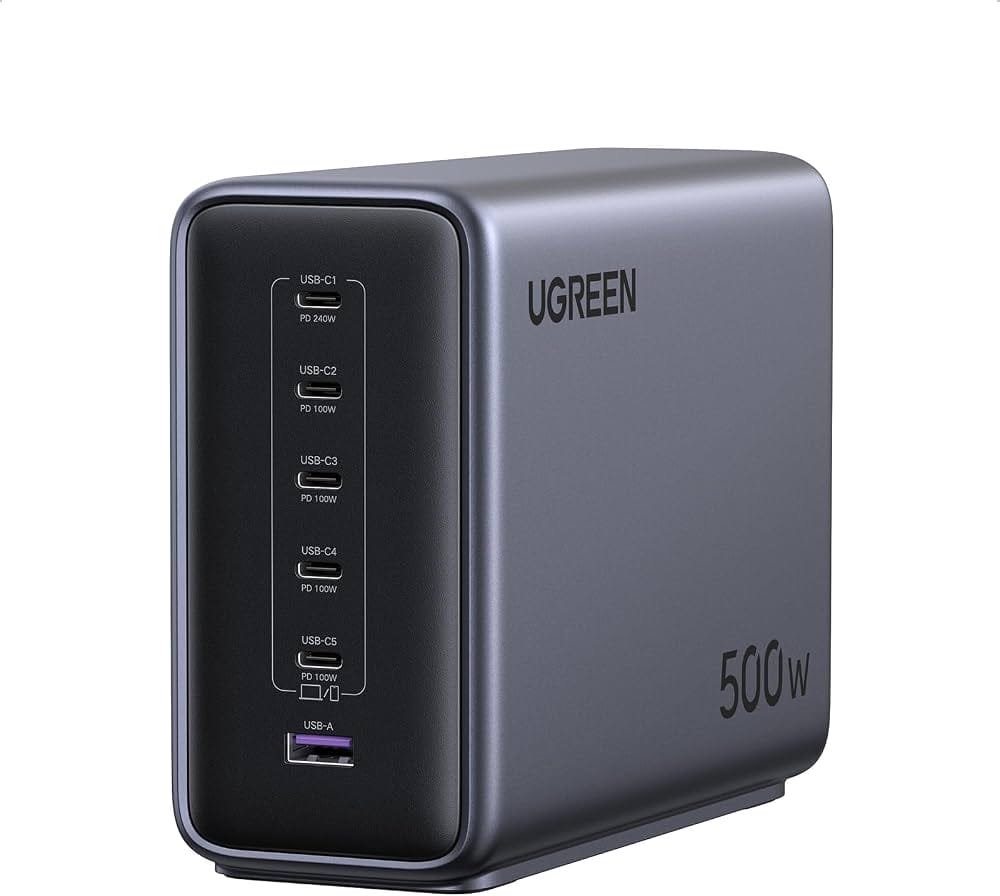 UGREEN Nexode 500W Charger The UGREEN Nexode 500W 6-Port GaN Desktop Charger in grey, placed on a white surface. It features the "UGREEN 500W" branding on the side, with multiple ports visible (5 USB-C, 1 USB-A). A short black power cord is attached to the charger. The image was captured on 31 May 2025 at 10:08 AM BST.