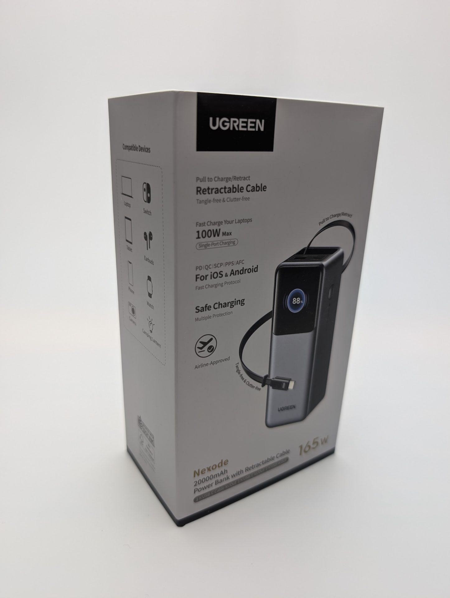 UGREEN Nexode Power Bank 20000mAh 165W with Retractable USB-C Cable UGREEN Nexode 20000mAh 165W Power Bank with Retractable USB-C Cable packaging. The box features a sleek black and silver power bank with a retractable cable and a digital display showing 88% charge. The packaging highlights 100W max single-port charging, PD/QC/iQ/SCP/UFCS protocols for iOS and Android, safe charging with multiple protections, and airline approval. Compatible devices include laptops, tablets, phones, Switch, earbuds, watches, cameras, and camping lanterns. The box also mentions a tangle-free and clutter-free design.