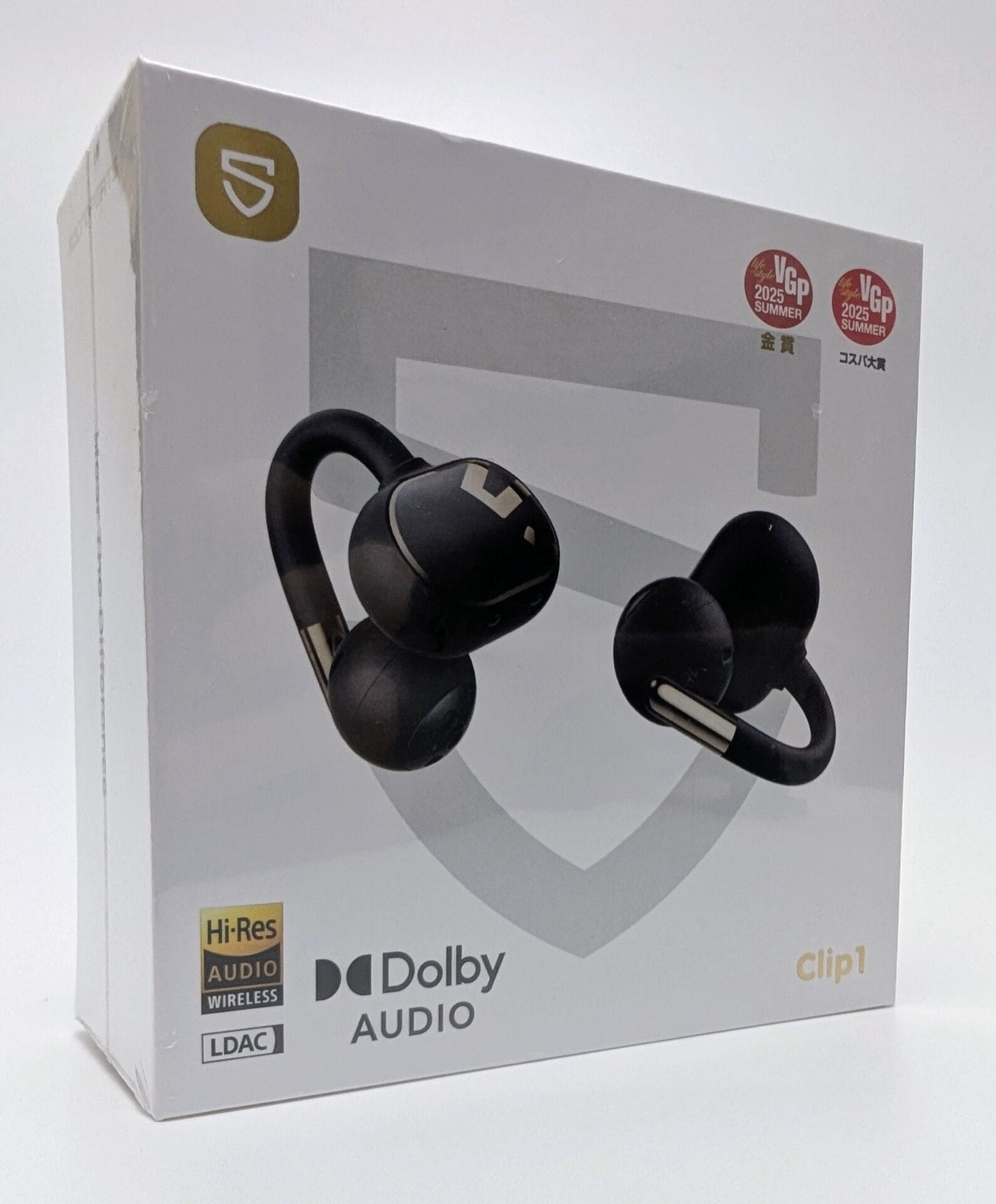 A sealed retail box of SoundPEATS Clip1 open-ear wireless earbuds in black. The box features a large image of the earbuds with their distinctive clip-on design and hook shape. Prominent labels include "HiRes Audio Wireless," "LDAC," "Dolby Audio," and "Clip1" in gold lettering. The packaging also displays two red VGP 2025 Summer award badges (one gold prize) in the top right corner, with Japanese text. The SoundPEATS logo appears in gold at the top left. The box is photographed against a plain white background.