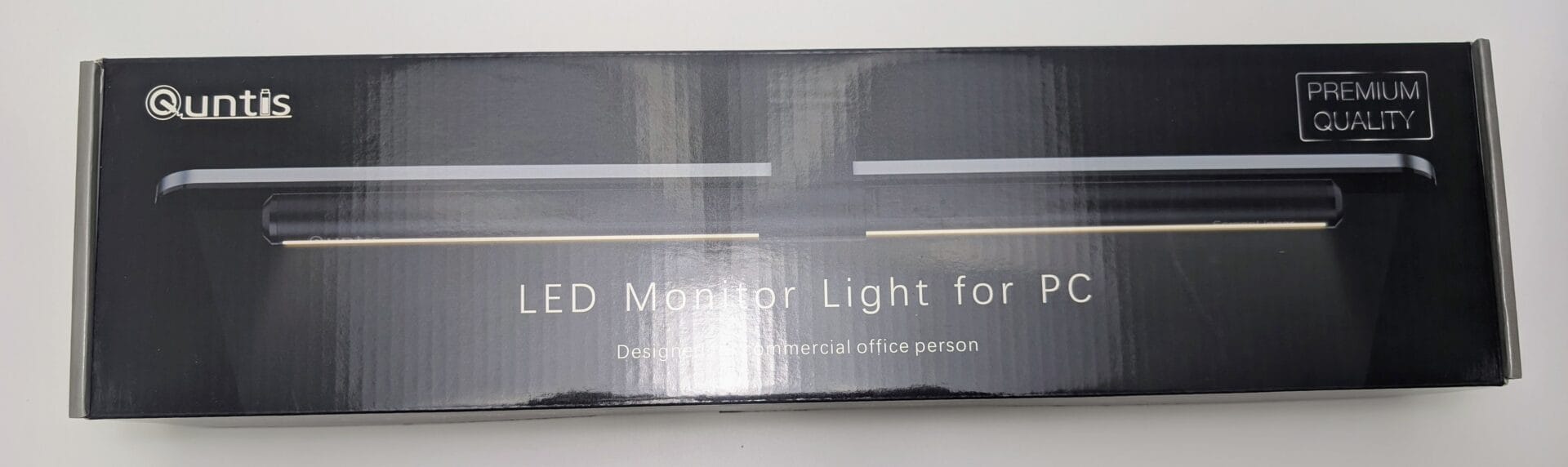 Quntis LED Monitor Light Bar in black premium packaging box, showing the slim clip-on desk lamp designed for computer monitors with eye-care features and no-glare illumination.