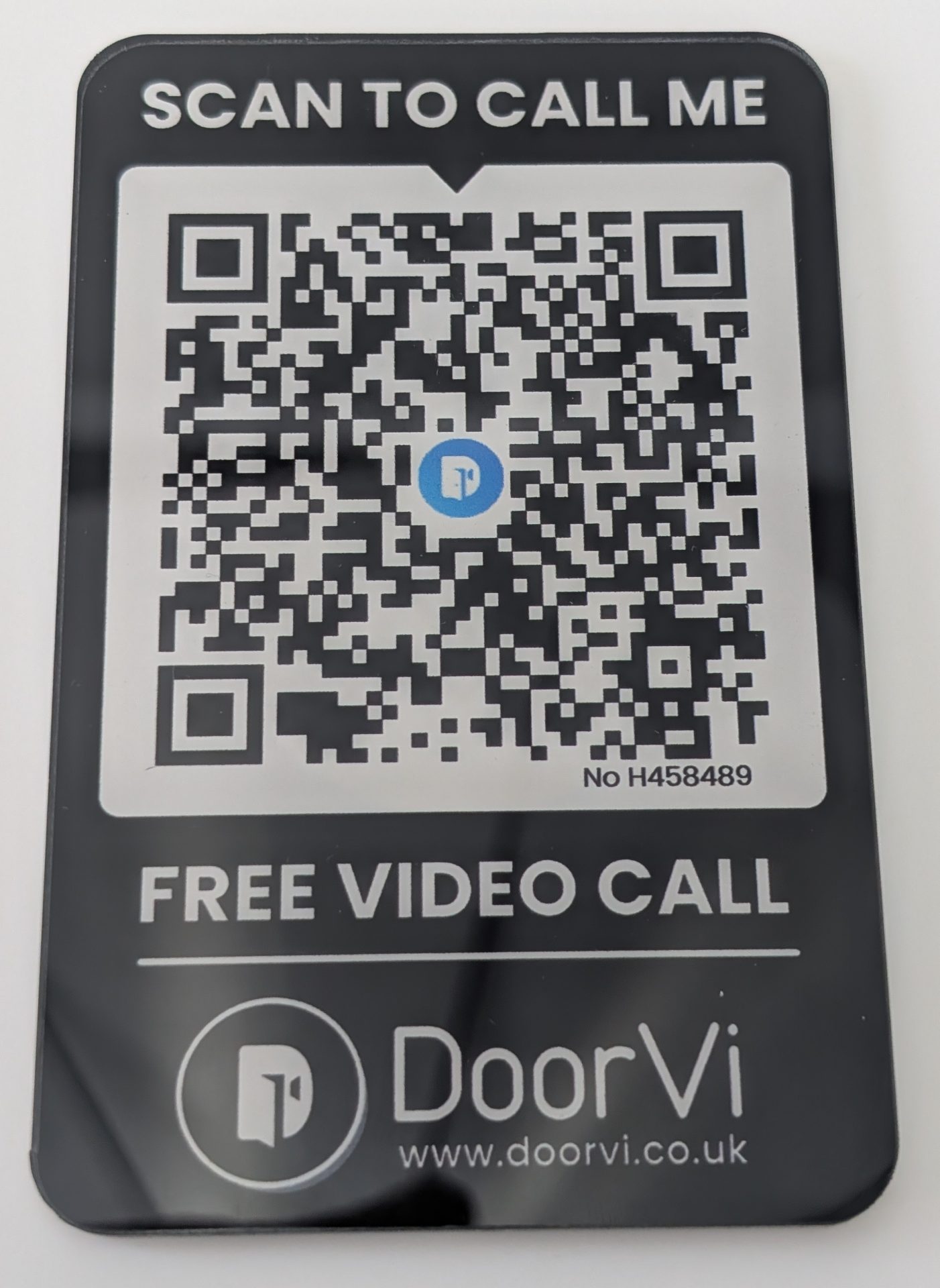 A black rectangular DoorVi plaque with a large QR code in the center. Text at the top reads 'SCAN TO CALL ME' and below the code 'FREE VIDEO CALL'. The DoorVi logo and website www.doorvi.co.uk appear at the bottom.