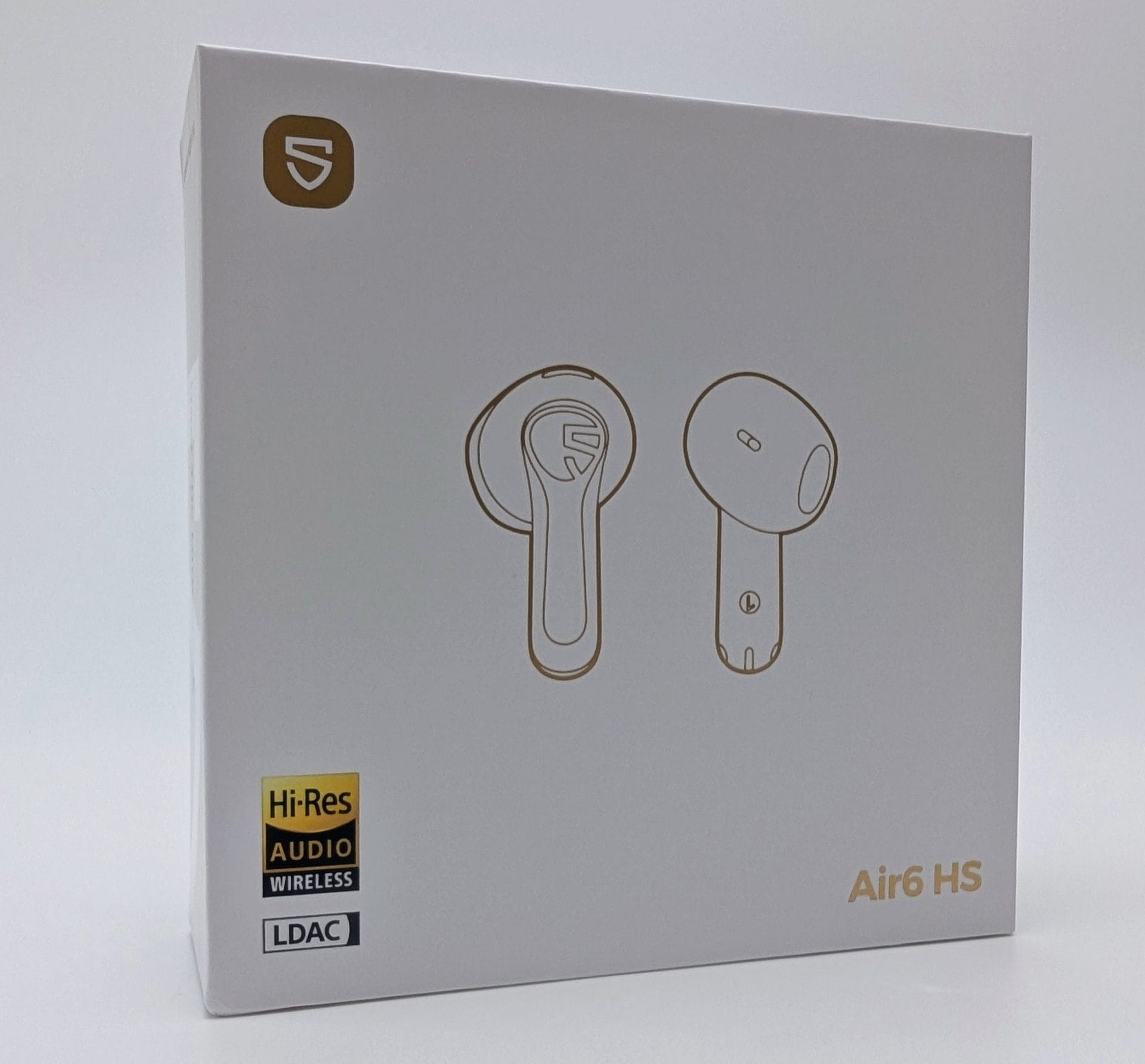 SoundPEATS Air6 HS White product packaging box for SoundPEATS Air6 HS true wireless earbuds, showing a gold shield logo in the top-left corner, gold line-art illustrations of the left and right earbuds in the center, a gold-and-black Hi-Res Audio Wireless badge and LDAC logo in the bottom-left, and the model name “Air6 HS” in gold text at the bottom-right.